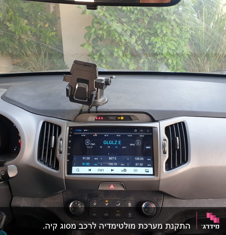 מערכת מולטימדיה ברכב עם מסך מגע ומעמד לטלפון